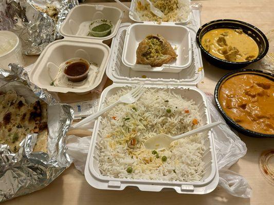 (Left to right) Garlic Naan, Rice 32oz, Chicken Samosa, Butter Chicken 16oz and Chicken Tikka Masala 16oz.