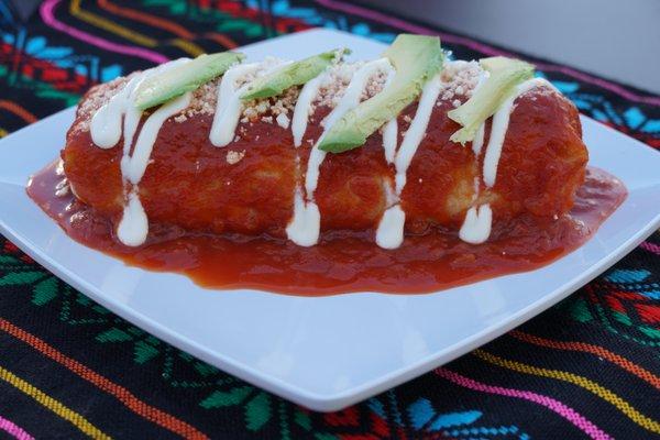 The wet burrito from the inside comes with beans rise oninos and cilantro and what on top of the burrito is sour cream and slice of avocado.