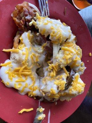 Heart attack on a plate, AKA breakfast "Topper #2". Biscuits topped w/ bacon, eggs, grilled onions, home fries, gravy & cheese.