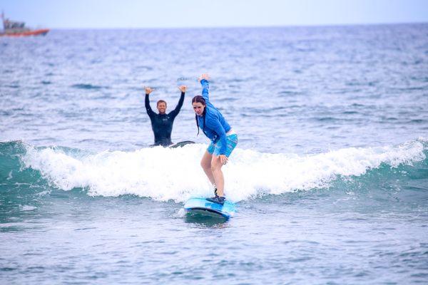 Surfing near Lahaina during a Maui Surfer Girls private lesson with instructor Josh. Photo by Maui Surfer Girls photographer Krystal.