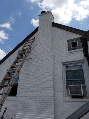 Repainting of chimney after pointed with masonry paint