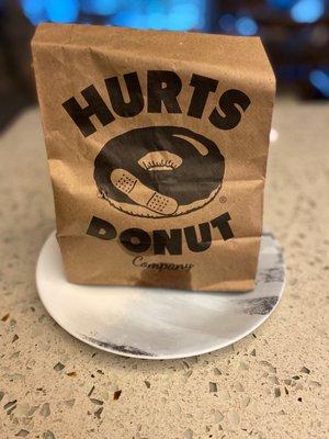 A logo with a bandaid on a donut - you'd barf if you really got one like that!