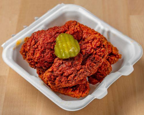 Nashville style Chicken wings with mild seasoning & a pickle on top