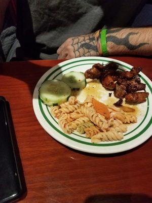 Delicious choices from the buffet here! Sliced cucumbers, peppered chicken, and noodles.