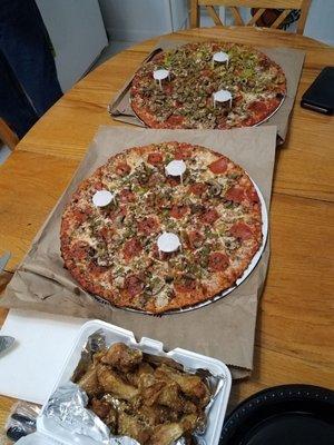 top pizza is large deluxe. bottom pizza is large delight. (garlic parm wings are from Harley's Hideout)