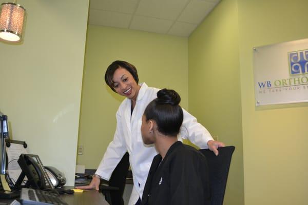 Dr Benson talking to the front desk worker Brittney.