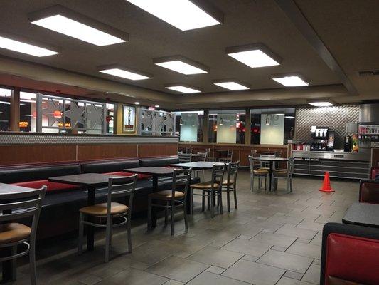 Inside dining area at night (cone out bc they're mopping the floors due to rain outside)