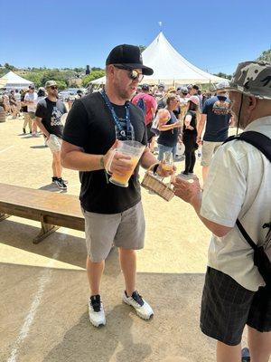 Cory King from Side Project pouring beers for folks waiting in line for his beers