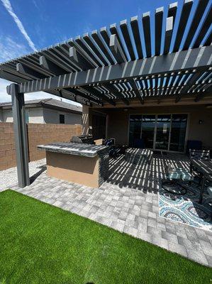 Outside space with pavers/alumawood pergola and kitchen build.