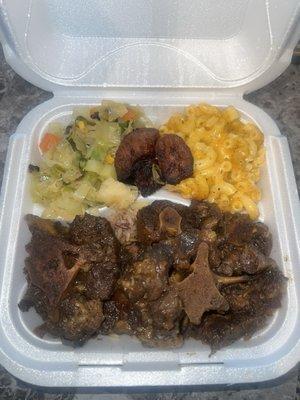 Oxtail, rice and peas, cabbage, plantains and mac