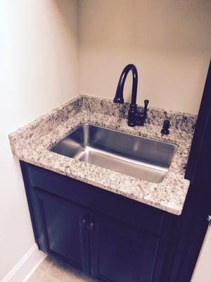 Granite laundry countertop with undermount stainless steel sink