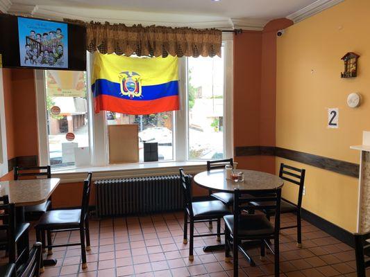 Interior of restaurant where flag is proudly displayed.