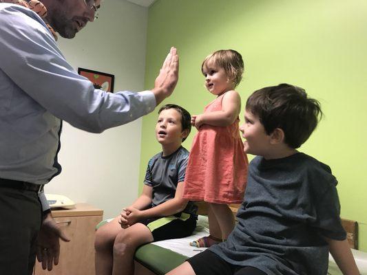 Dr. Feazell getting my three pumped for their annual flu shot.