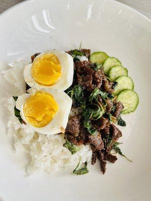 Thai holy basil beef with boiled egg over rice.