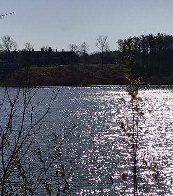 Sun reflection on the lake with the manor across the way.