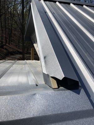 Flashing does not cover wood trim and is not secured.