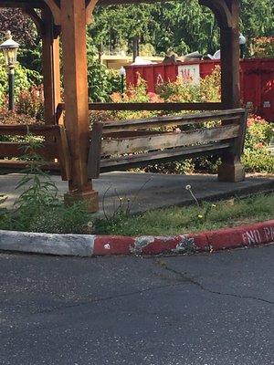 This is the outside sitting/smoking area with old cracked paint, for patients surrounded by tall weeds.