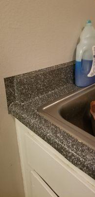 Cheap vinyl wrapped counter tops...can't even trim the vinyl???