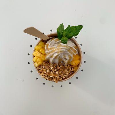 Go mango Bowl - banana based soft serve topped with fresh mango, pineapple, house granola Ming and honey