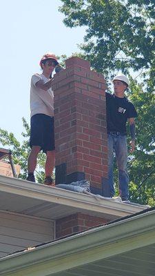 Our Certified Chimney professionals hard at work rebuild the top of a chimney.