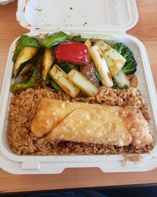 Beef with vegetables, egg roll and fried rice.