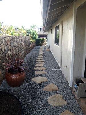 After photo of stumps and roots removed and installation of drainage and xeriscape. Also the addition of Big Rock tan lava stepping stones.