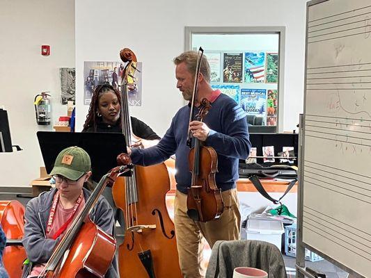 Helping a string player while on tour in Georgia