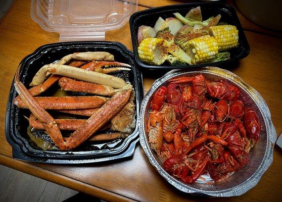 Steamed crab legs, crawfish, and veggies.