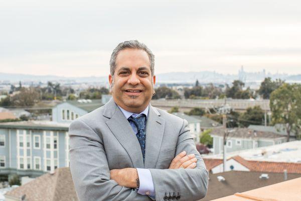 Vic Joshi, Mortgage Consultant, on his rooftop patio overlooking the city of Oakland and the East Bay Area