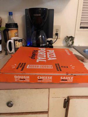 Pizza box, coffee maker and cups.