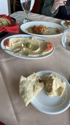 Fresh pita with hummus and eggplant appetizers.