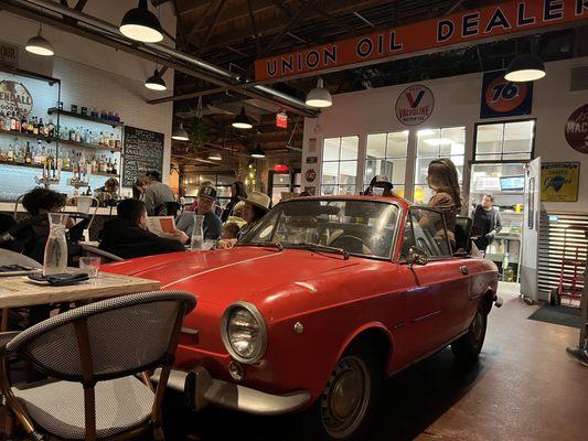 Centerpiece vintage Fiat where two diners sit and enjoy their meal