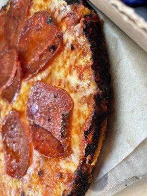 Pizza with burnt edges