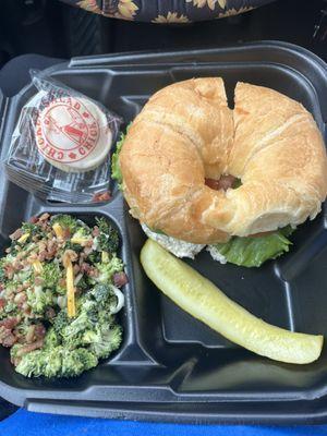 Sassy Scottie Croissant sandwich with a side of broccoli. It came with a pickle spear and a frosted cookie!! Such a sweet surprise.