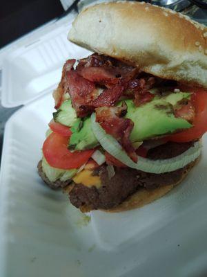 Juarez style burger. Avocado lettuce tomato onion bacon American cheese chipotle mayo hot dog on sesame seed bun.