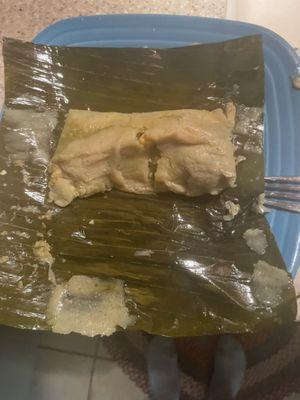 Chicken tamale wrapped in banana leaf