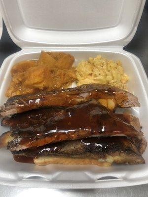 Pork long ribs smothered in barbecue sauce with candied yams and baked Mac&cheese