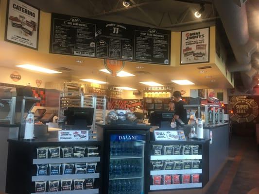 Employee sitting on the food counter. Who does that?! Gross.