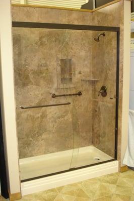 Light Mocha Travertine wall system with matching shower pan.