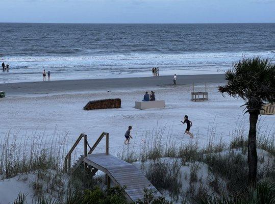 Beach view of the boys playing football