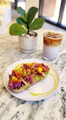 Avocado Garden Toast: country loaf topped w/ cherry tomato, pickled veggies, chives & a drizzle of cilantro infused olive oil