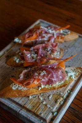 Crostini with prosciutto and truffle oil