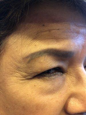 My poor mom tried to touch up her old eyebrow tattoo, but they didn't follow the old outline.