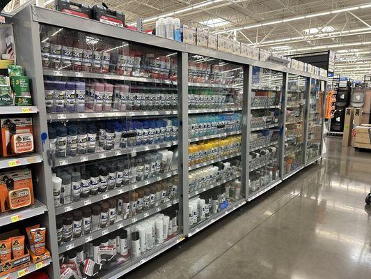 Spray paint cans in a locked glass cabinet that made browsing easy and kept the cans clean.