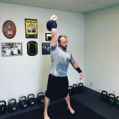 Leading by example takes work. Here's Chris getting in his reps in a clean and press workout ladder.