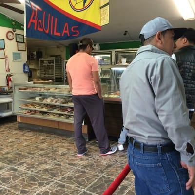 Inside, pastries to the left, savory options to the right - long lines mean good food, especially this early!