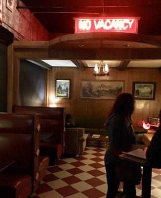 A handful of booths, couches, and high top tables in the bar