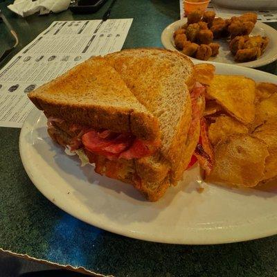 Ham Club sandwich, homemade chips, and a side fried okra.