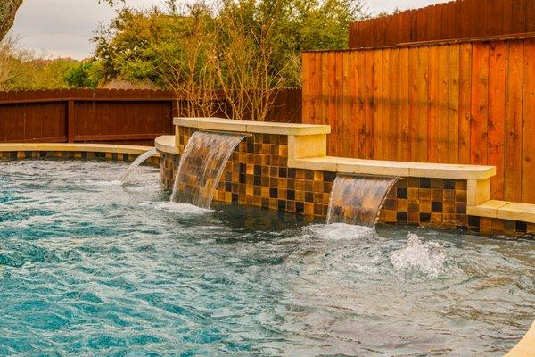 Custom pool with sheer fountains.