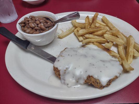 Chicken fried steak and 2 sides, fries and pinto beans.